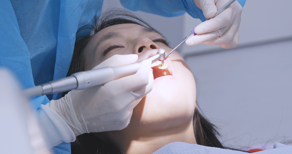 Woman undergo check up of tooth in dental clinic