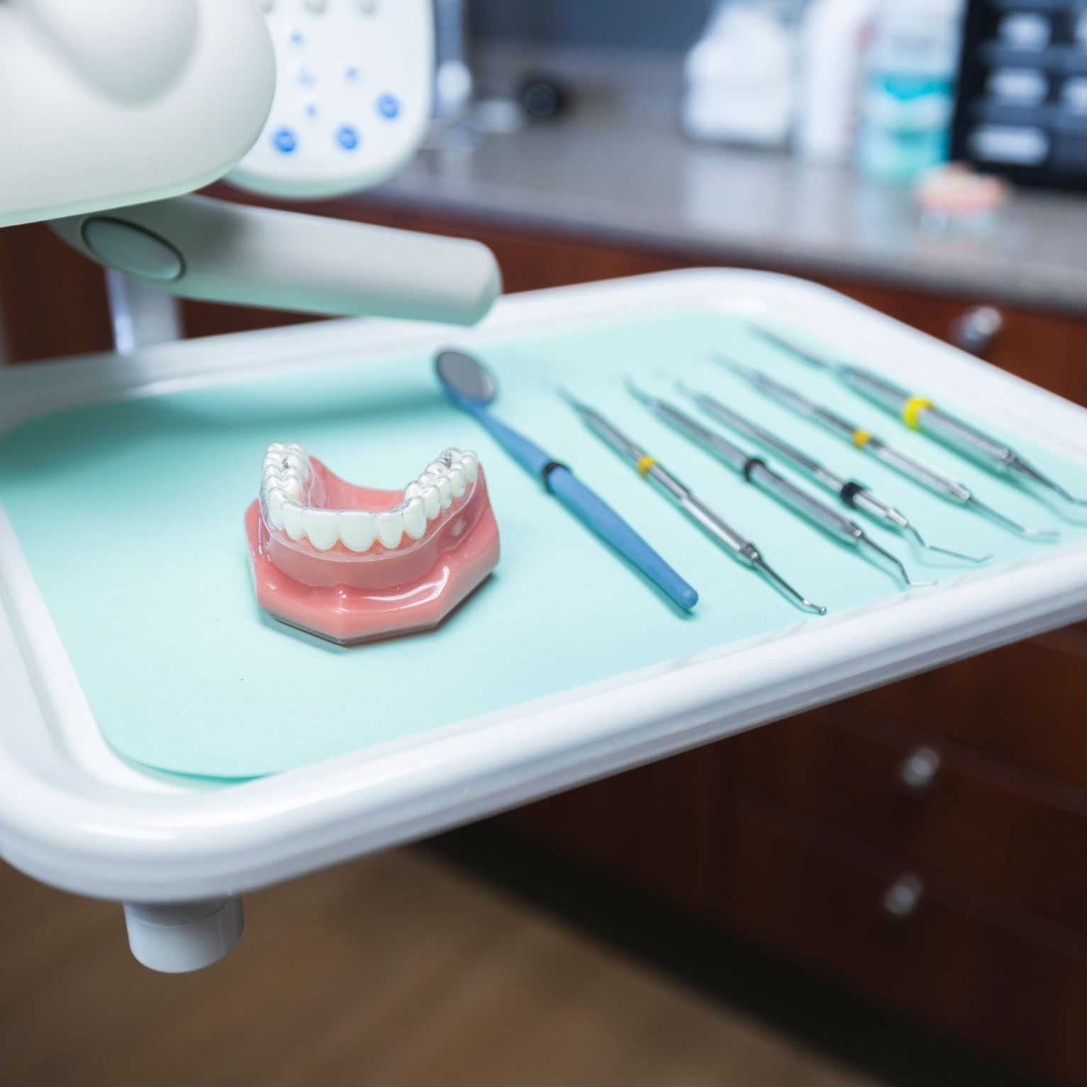 Dental tray prepared with instruments and tooth model for treatment demonstration